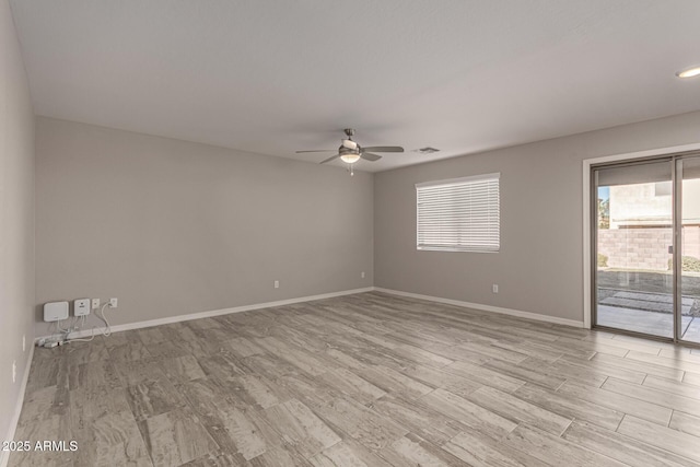 unfurnished room with ceiling fan and light wood-type flooring