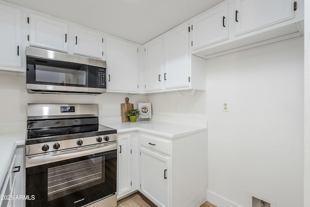 kitchen with white cabinets and appliances with stainless steel finishes