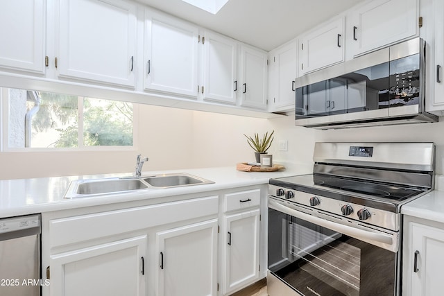 kitchen featuring sink, white cabinets, and stainless steel appliances