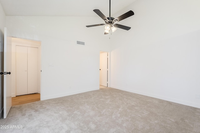 carpeted spare room with high vaulted ceiling and ceiling fan