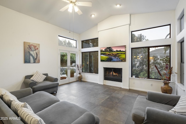 living room featuring ceiling fan, high vaulted ceiling, and french doors