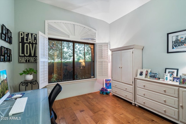 office area with vaulted ceiling and light wood-type flooring