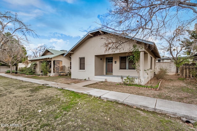 bungalow-style home featuring a front yard