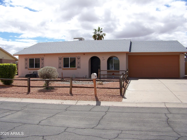 ranch-style home featuring stucco siding, driveway, a fenced front yard, roof with shingles, and a garage