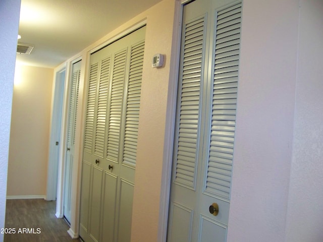 interior space with visible vents, dark wood-style floors, and baseboards