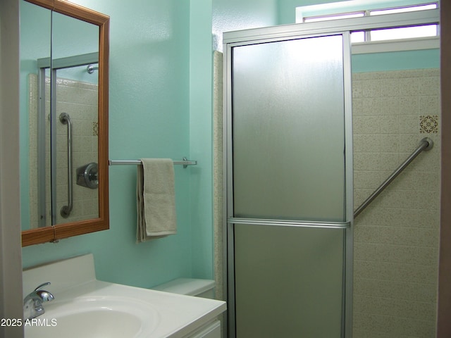 bathroom featuring a stall shower and vanity