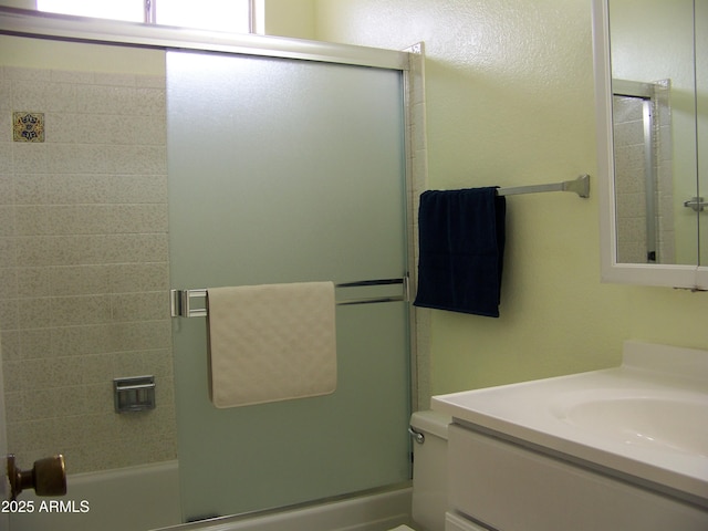 full bath featuring vanity and shower / bath combination with glass door