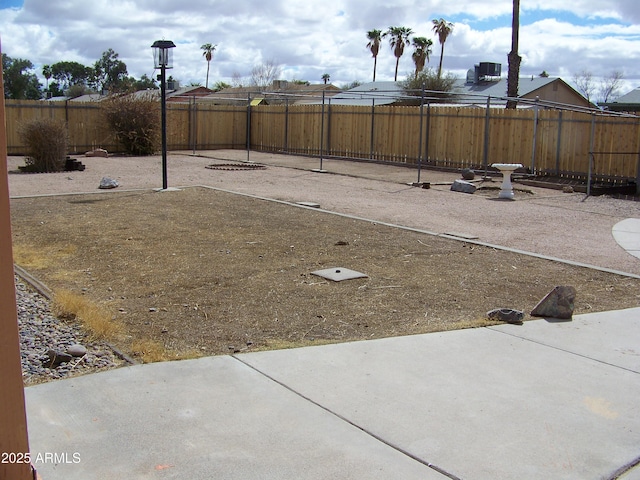 view of yard with cooling unit, a patio, and a fenced backyard