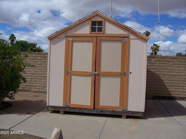 view of shed with a fenced backyard