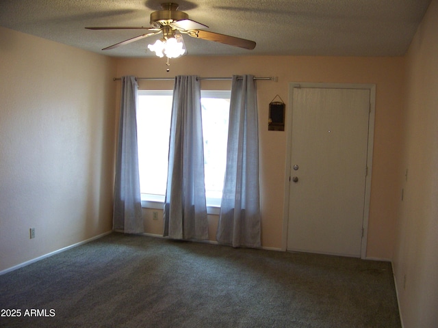 carpeted empty room with a textured ceiling and ceiling fan