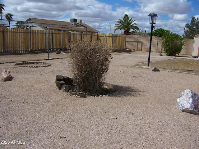 view of yard with cooling unit and fence