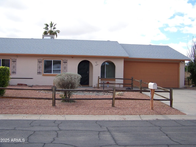 view of front of house featuring stucco siding, an attached garage, concrete driveway, and roof with shingles