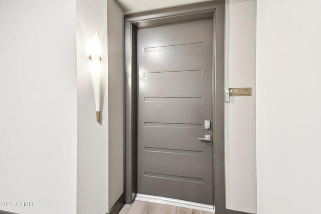 doorway to outside with light wood-type flooring