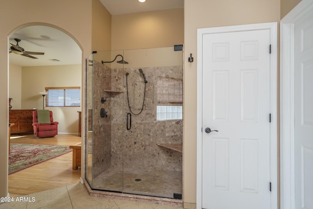 bathroom featuring tile patterned flooring, ceiling fan, a healthy amount of sunlight, and an enclosed shower