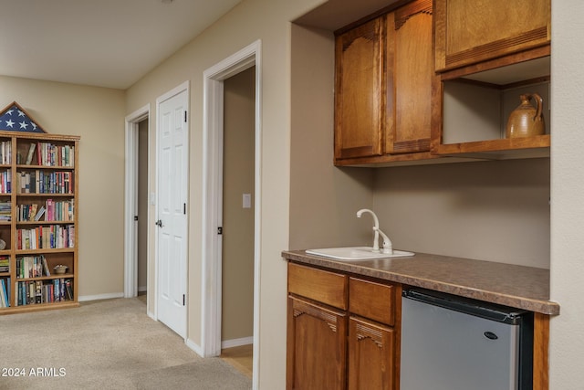 kitchen with light colored carpet and sink