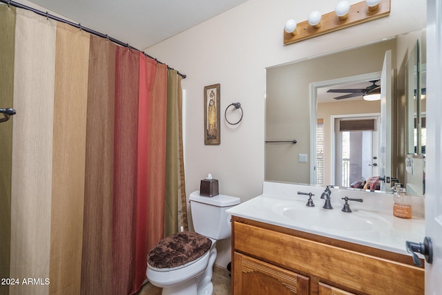 bathroom featuring vanity, ceiling fan, toilet, and walk in shower