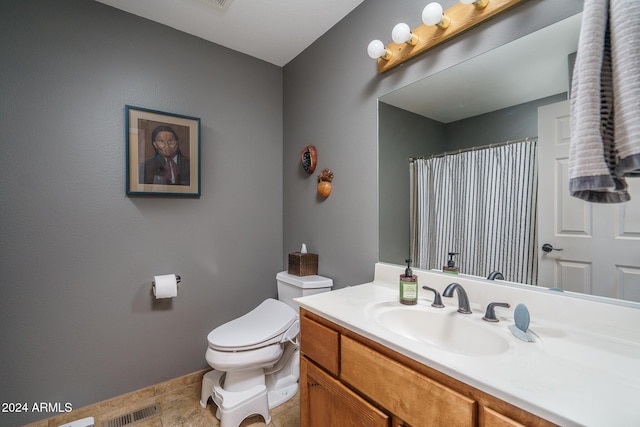 bathroom with tile patterned floors, vanity, and toilet