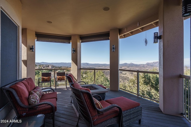 deck with a mountain view and an outdoor fire pit