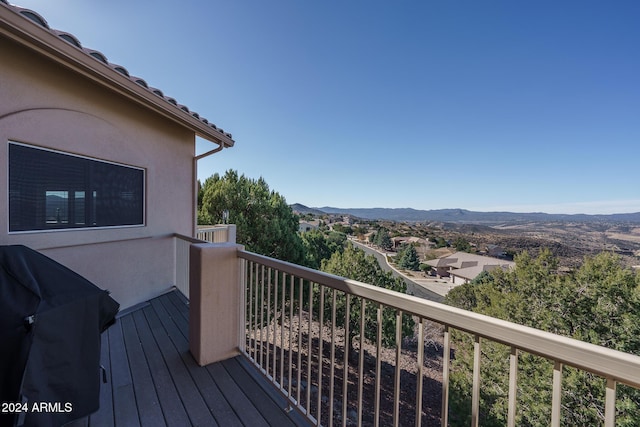 deck featuring a grill and a mountain view