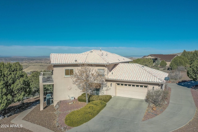 view of front of home with a balcony and a garage