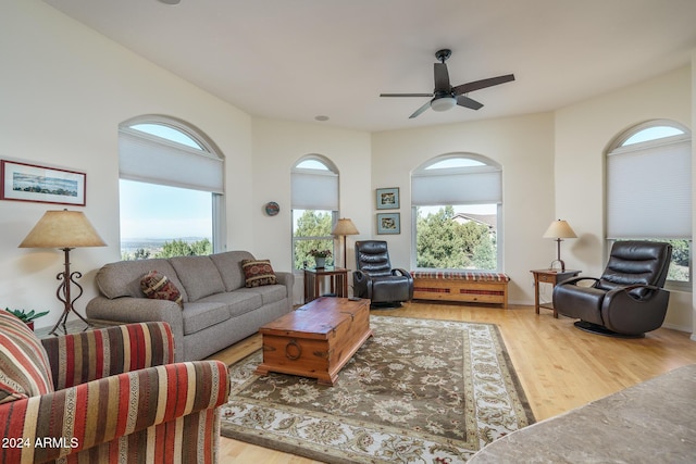 living room with light wood-type flooring and ceiling fan