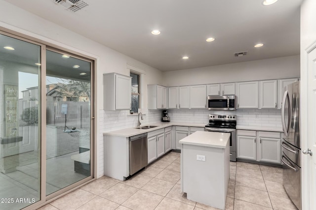 1647 W Gold Mine Way, San Tan Valley, AZ 85144 - kitchen with appliances with stainless steel finishes, a sink, a center island, tasteful backsplash, and light countertops