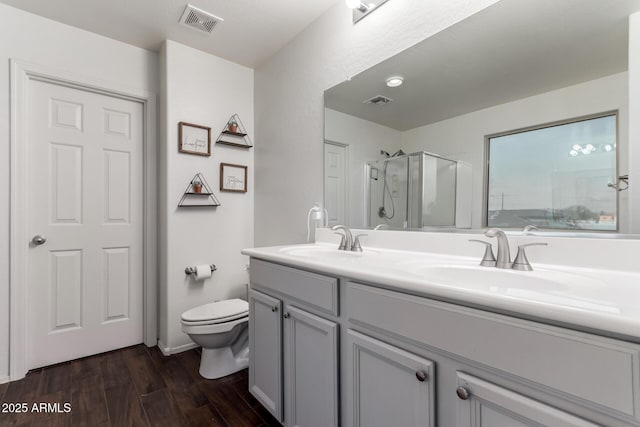 1647 W Gold Mine Way, San Tan Valley, AZ 85144 - full bathroom with wood finished floors, toilet, a shower stall, and double vanity