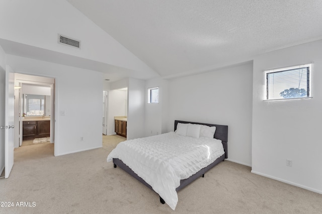 carpeted bedroom featuring multiple windows, connected bathroom, and lofted ceiling