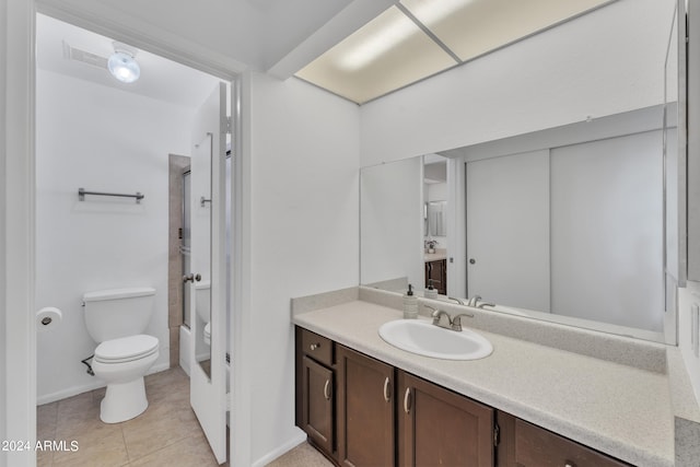 full bathroom featuring vanity, toilet, tile patterned floors, and washtub / shower combination