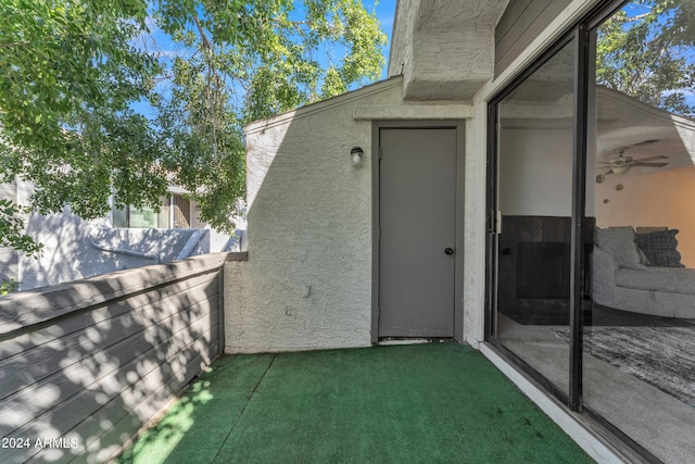 entrance to property featuring ceiling fan