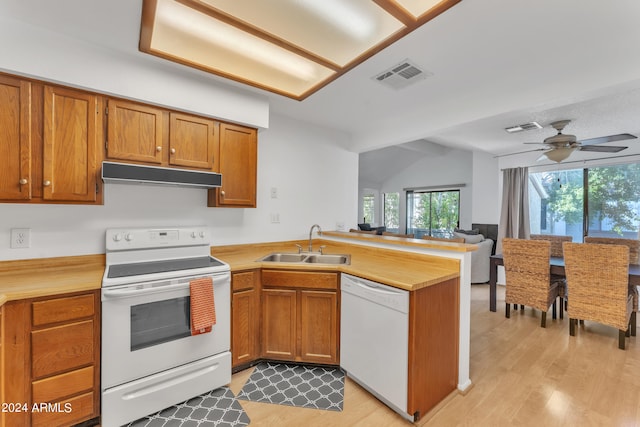 kitchen featuring white appliances, sink, light hardwood / wood-style floors, ceiling fan, and lofted ceiling