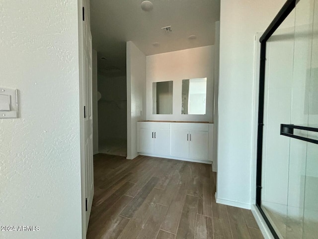 hallway with dark hardwood / wood-style floors