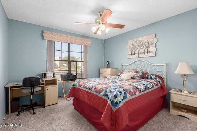 bedroom with a textured ceiling, light colored carpet, and ceiling fan