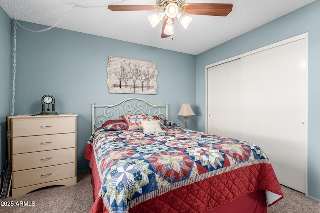 carpeted bedroom with a textured ceiling, a closet, and ceiling fan