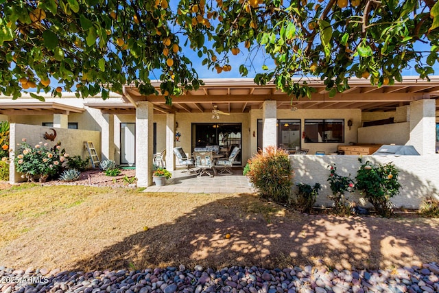 rear view of house featuring a patio and ceiling fan