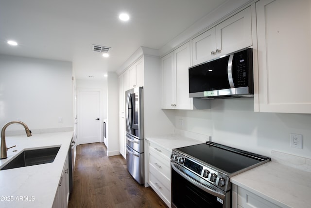 4525 N 66th St Unit 95, Scottsdale, AZ 85251 - kitchen featuring stainless steel appliances, a sink, recessed lighting, dark wood-style flooring, and light stone countertops