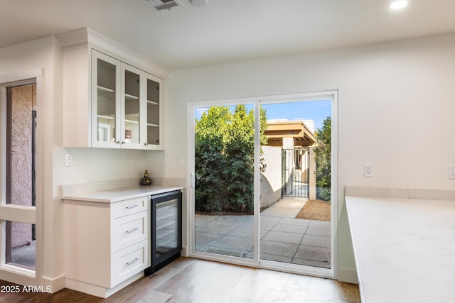 4525 N 66th St Unit 95, Scottsdale, AZ 85251 - indoor dry bar with wine cooler, light wood-type flooring, and recessed lighting