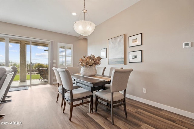 dining area featuring baseboards and wood finished floors