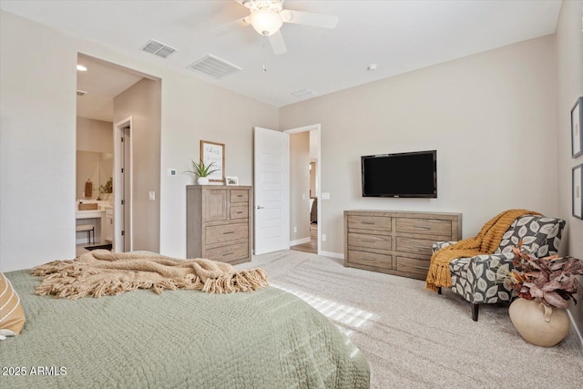 carpeted bedroom with ensuite bath, visible vents, and ceiling fan