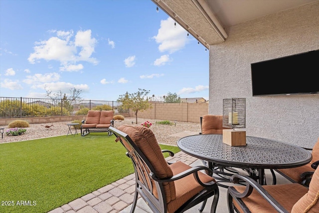 view of patio / terrace with outdoor dining space and a fenced backyard