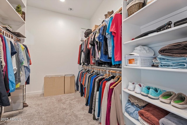 walk in closet with visible vents and carpet flooring