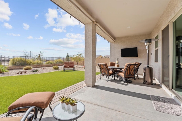 view of patio with outdoor dining space and a fenced backyard