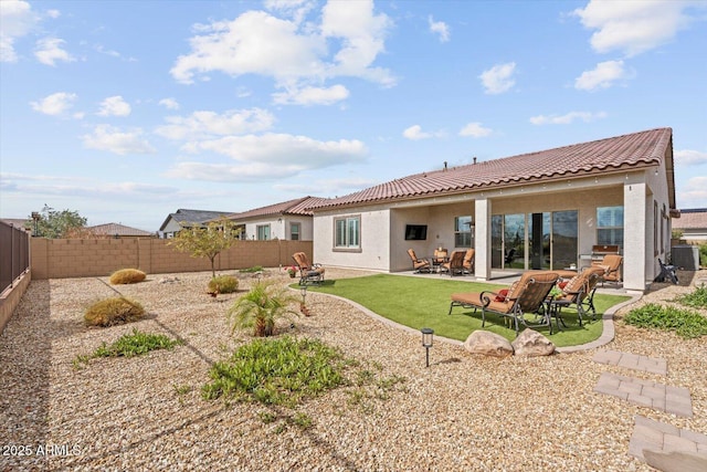 back of house featuring a patio area, a fenced backyard, central AC, and stucco siding