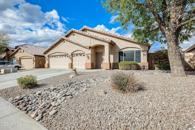 view of front facade with stucco siding, a garage, and concrete driveway