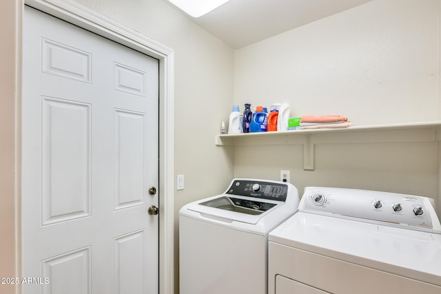 clothes washing area with laundry area and washer and clothes dryer