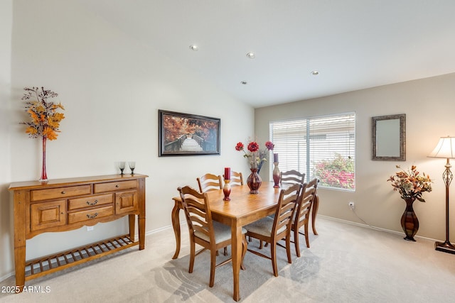 dining space with recessed lighting, light colored carpet, baseboards, and vaulted ceiling