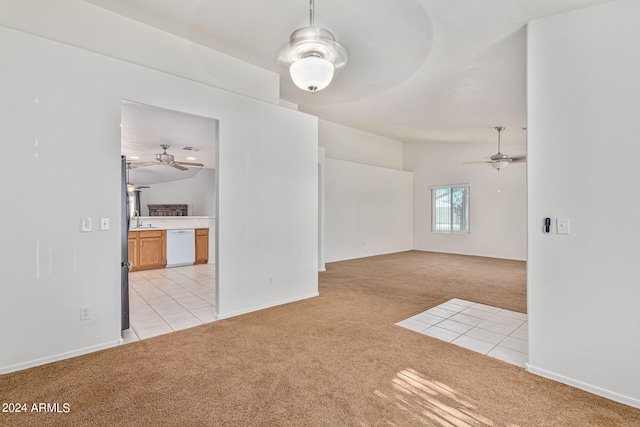 empty room featuring ceiling fan, light carpet, vaulted ceiling, and sink