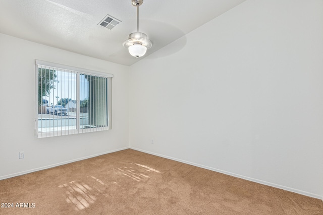 carpeted empty room featuring ceiling fan