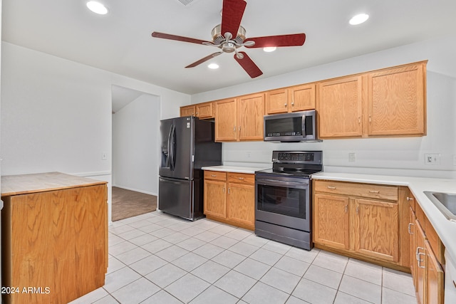 kitchen with ceiling fan, electric stove, light tile patterned floors, and black fridge