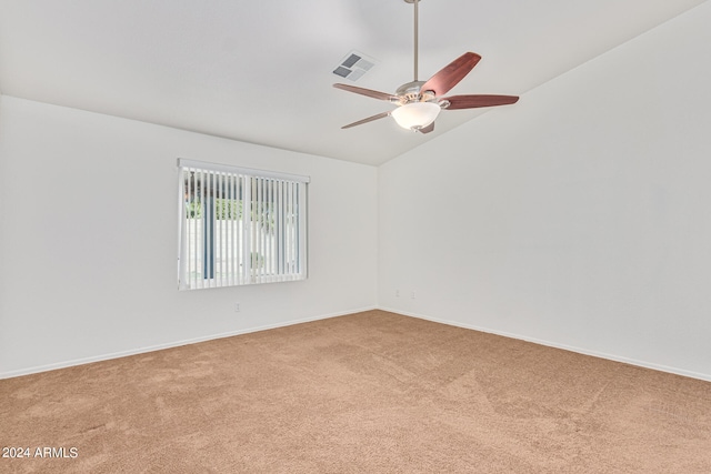 carpeted spare room featuring ceiling fan and lofted ceiling